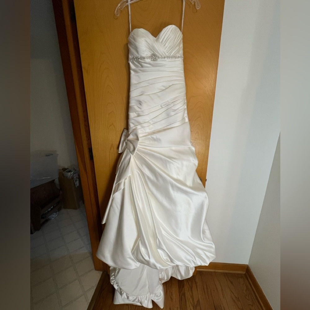 Ivory sweetheart bodice with beaded empire waistline .